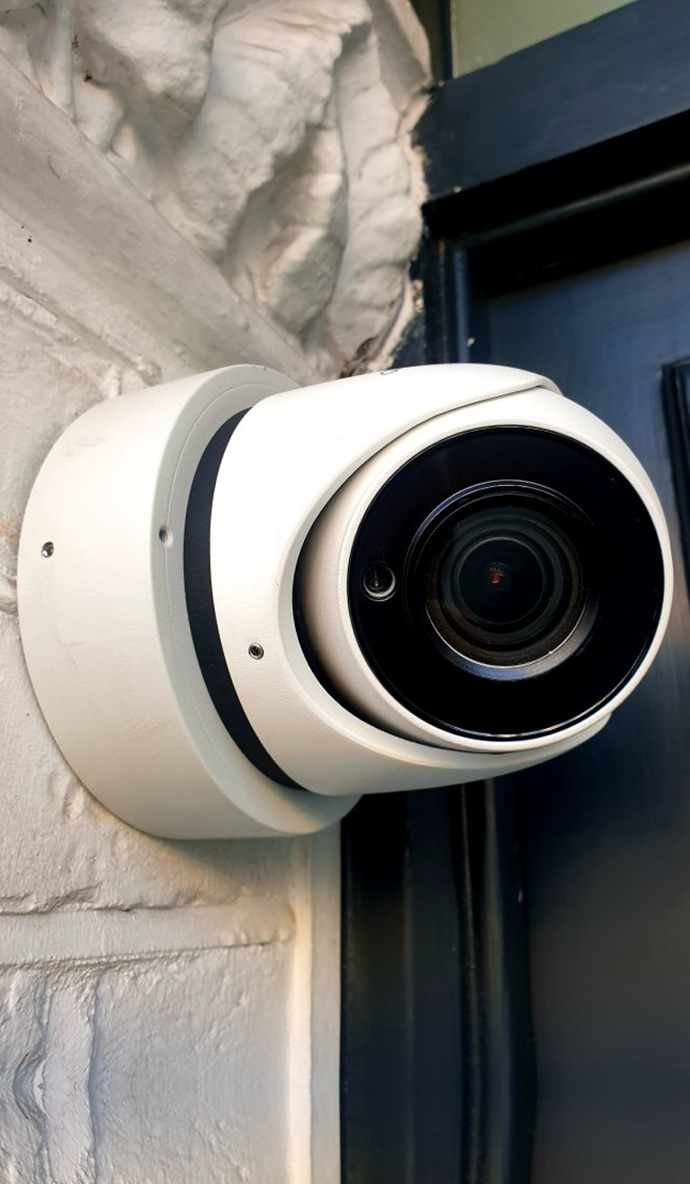 Dome security camera mounted on wall