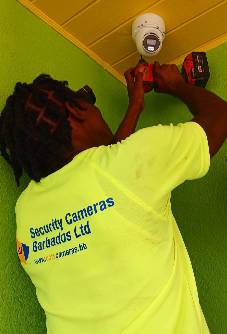 Security Cameras Barbados technician installing CCTV camera